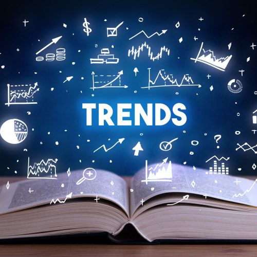 TRENDS inscription coming out from an open book, business concept